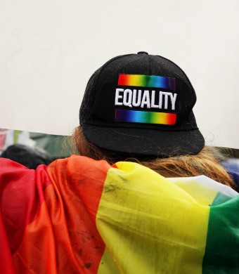 A rainbow cap reading equality